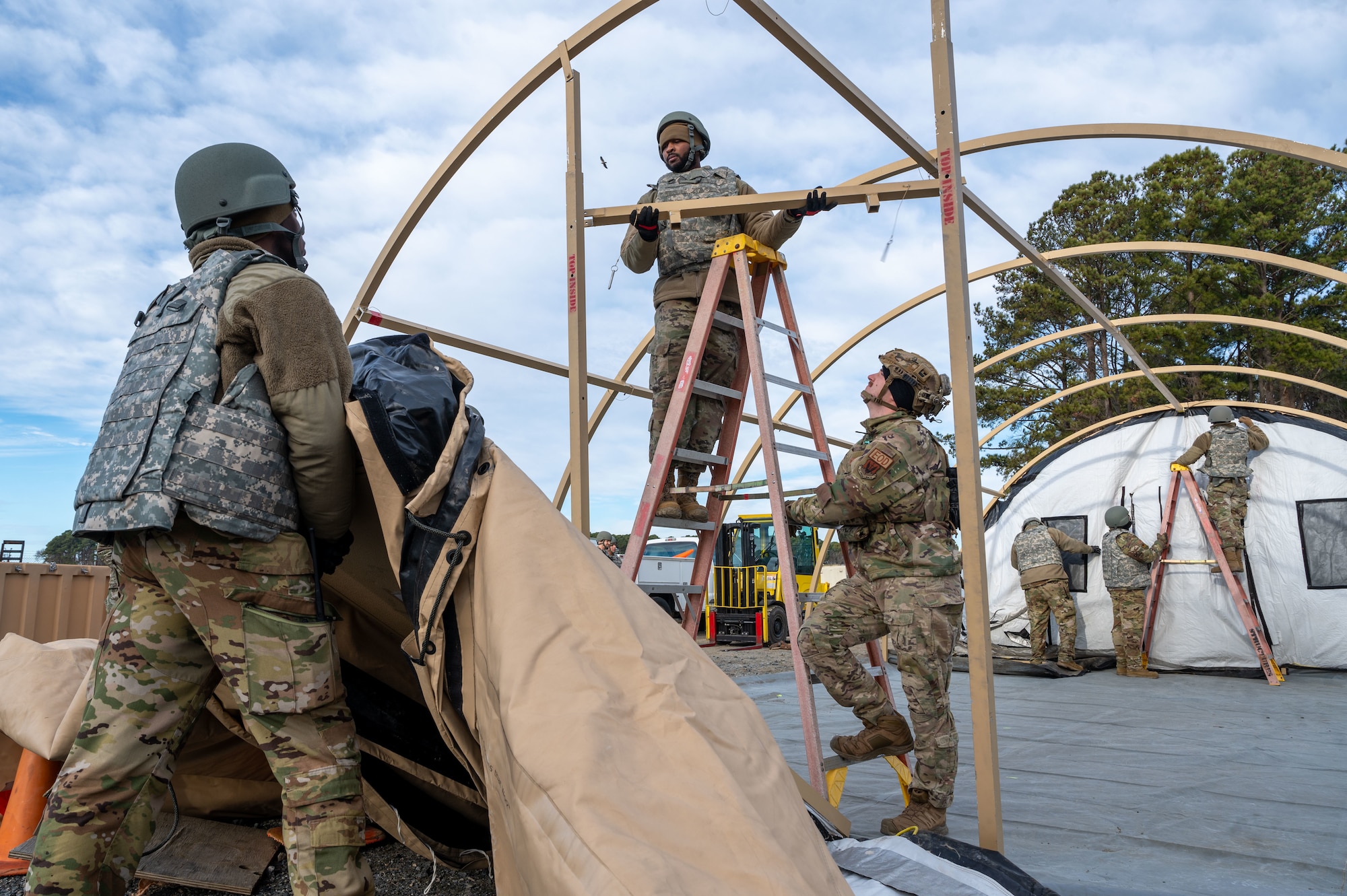 Airmen hold up and position door frame. (U.S. Air Force photo by Airman Donnell Ramsey)