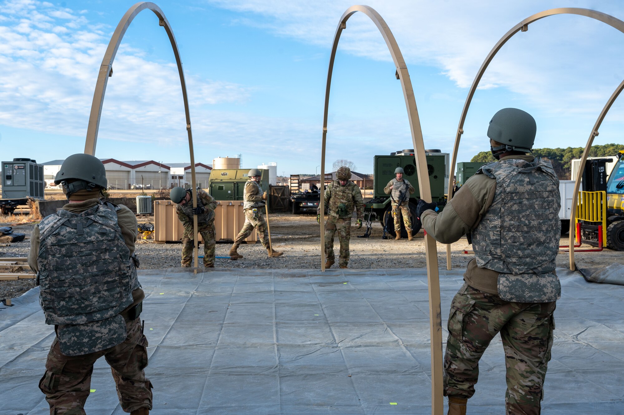 Airmen hold two metal frames. (U.S. Air Force photo by Airman Donnell Ramsey)