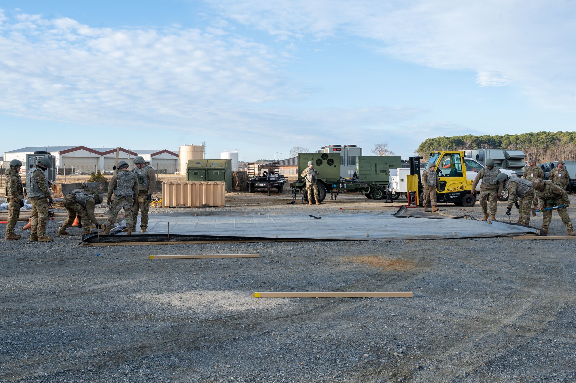 Airmen hammer stakes in the ground. (U.S. Air Force photo by Airman Donnell Ramsey)