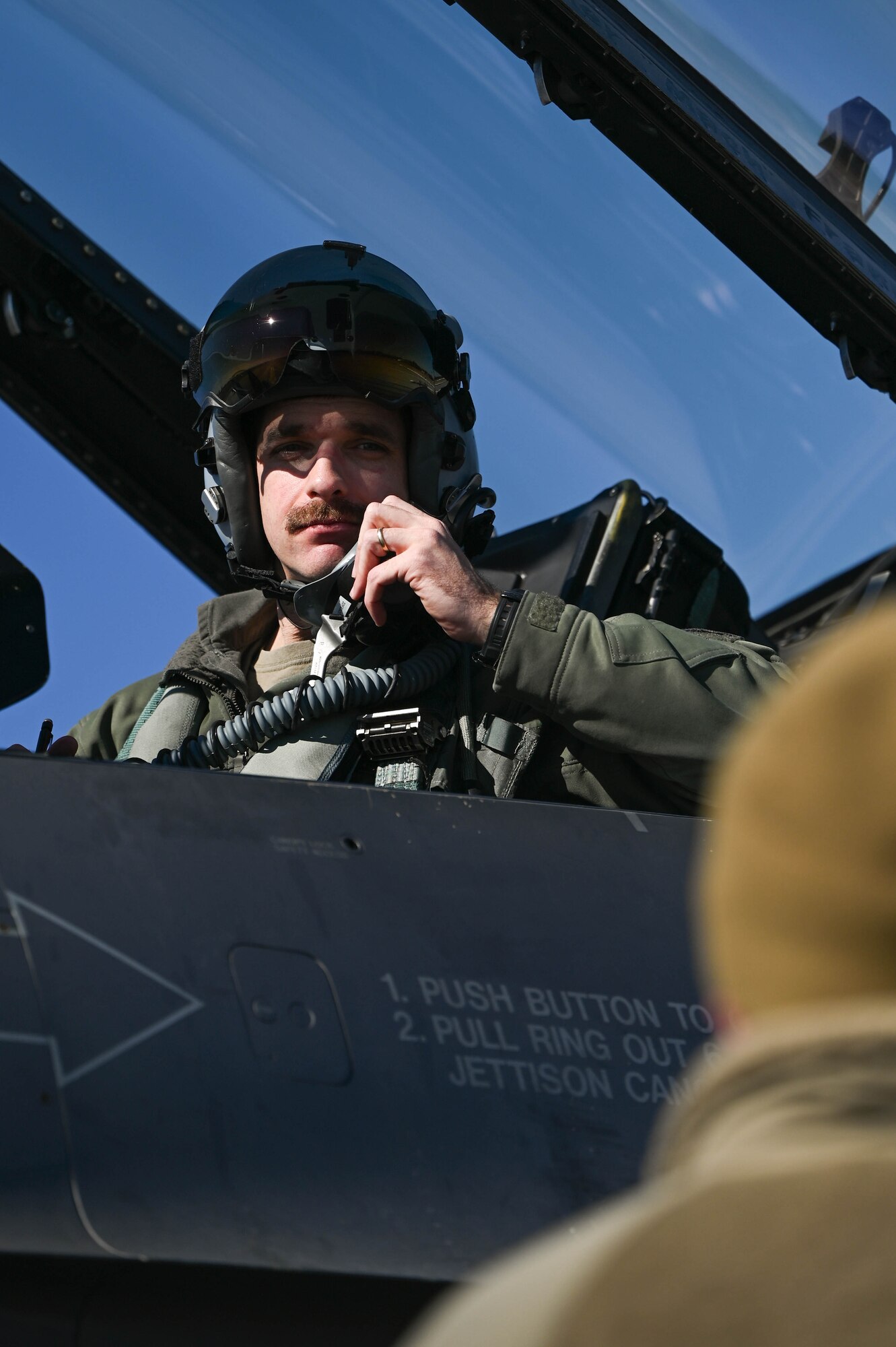U.S. Air Force Maj. David Leedom, 157th Fighter Squadron pilot, McEntire Joint National Guard Base, South Carolina, converses with a crew chief after an arresting cable certification at Joint Base Charleston, S.C., Jan. 28, 2025. An arresting cable certification is an annual requirement for the 437th Operations Support Squadron airfield management team testing the Barrier Arresting Kit-12 arresting cable system for pilots to execute a safe emergency landing.
