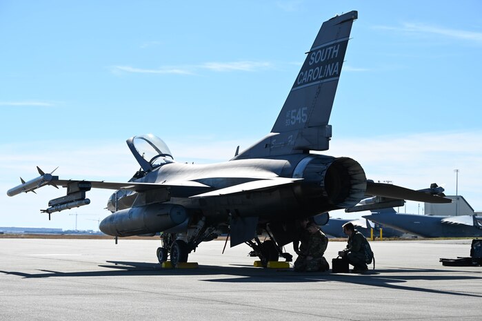 U.S. Air Force Tech. Sgt. Eric Weishuhn and Staff Sgt. Ryan Crawford, 169th Aircraft Maintenance Squadron crew chiefs, and Maj. David Leedom, 157th Fighter Squadron pilot, McEntire Joint National Guard Base, South Carolina, conducts post-flight equipment inspections after completing an arresting cable certification at Joint Base Charleston, S.C., Jan. 28, 2025. Joint Base Charleston works in conjunction with different bases to maximize mission performance through safety training procedures and annual certifications.