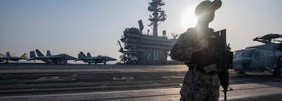 LAEM CHABANG, Thailand (Jan. 31, 2025) — Master-at-Arms 1st Class Justin Genova, of Burbank, Calif., stands watch on the flight deck of the Nimitz-class aircraft carrier USS Carl Vinson (CVN 70) as the ship gets underway in Laem Chabang, Thailand, Jan. 31, 2025, after a scheduled port visit. The visit demonstrates the continuation of a long-standing partnership between allied countries rooted in close people-to-people, economic and security ties. (U.S. Navy photo by Mass Communication Specialist 3rd Class Nate Jordan)