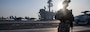 Master-at-Arms 1st Class Justin Genova, of Burbank, Calif., stands watch on the flight deck of the Nimitz-class aircraft carrier USS Carl Vinson (CVN 70) as the ship gets underway in Laem Chabang, Thailand, Jan. 31, 2025.