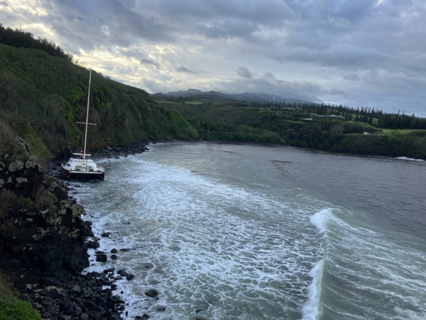 The Hula Girl, a 65-foot commercial catamaran, sits aground on the north side of Honolua Bay in Maui Jan. 31, 2025. Coast Guard Marine Safety Team Maui personnel assessed the scene and reported no signs of pollution. (U.S. Coast Guard photo, courtesy Department of Land and Natural Resources)