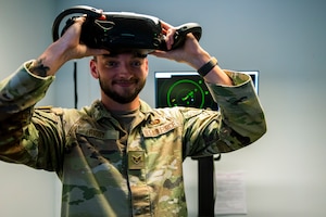 U.S. Air Force Senior Airman Jacob Rigby, 39th Operations Support Squadron air traffic control trainer, holds a virtual reality headset during a training session at Incirlik Air Base, Türkiye, June 30, 2025.