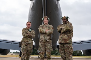 U.S. Air Force Airman 1st Class Kayla Arnold, left, Airman Nicholas Blair, center, and Airman 1st Class Joshua Samuel, 100th Aircraft Maintenance Squadron crew chiefs, pose for a photo behind a KC-135 Stratotanker from the 100th Air Refueling Wing at RAF Mildenhall, England, June 24, 2025.