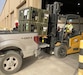 Staff members at the Army Prepositioned Stocks site at Camp Arifjan, Kuwait, known as APS-5, load blood freezers onto a 3rd Medical Command (Forward) truck in preparation for a training exercise in June.