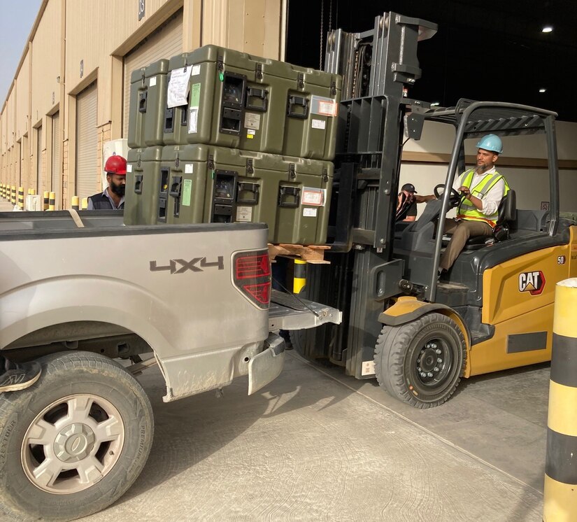 Staff members at the Army Prepositioned Stocks site at Camp Arifjan, Kuwait, known as APS-5, load blood freezers onto a 3rd Medical Command (Forward) truck in preparation for a training exercise in June.
