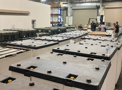 Staff members at the Army Prepositioned Stocks site at Camp Arifjan, Kuwait, known as APS-5, prepare equipment and supplies for hand-off to 3rd Medical Command (Forward) to establish a forward resuscitative surgical detachment as part of an emergency deployment readiness exercise, or EDRE, in June.