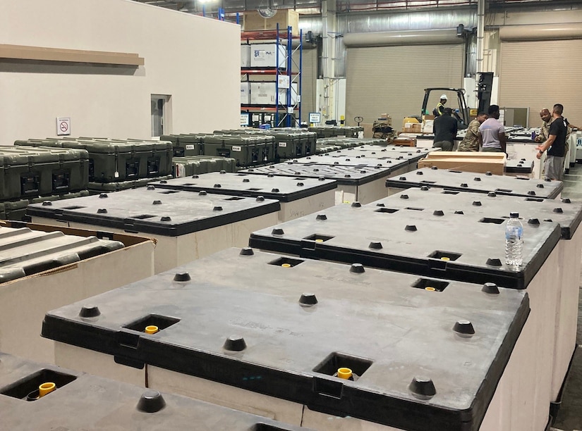 Staff members at the Army Prepositioned Stocks site at Camp Arifjan, Kuwait, known as APS-5, prepare equipment and supplies for hand-off to 3rd Medical Command (Forward) to establish a forward resuscitative surgical detachment as part of an emergency deployment readiness exercise, or EDRE, in June.