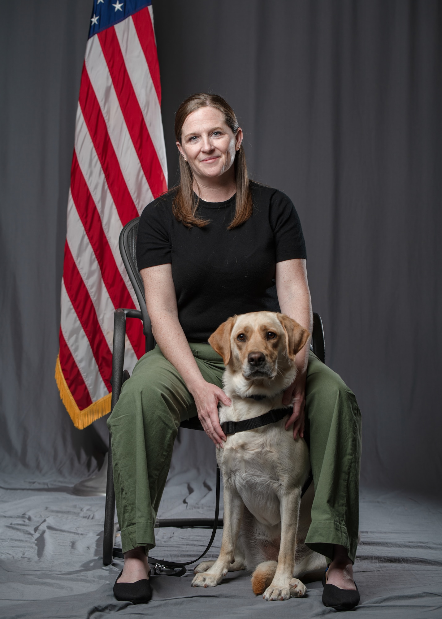 Nichole Gruber, integrated primary prevention workforce integrator, 114th Fighter Wing, leads the Wing’s facility therapy dog initiative to promote mental wellness, support emotional regulation, and strengthen connection among Airmen. (U.S. Air National Guard photo by Staff Sgt. Taylor Solberg)