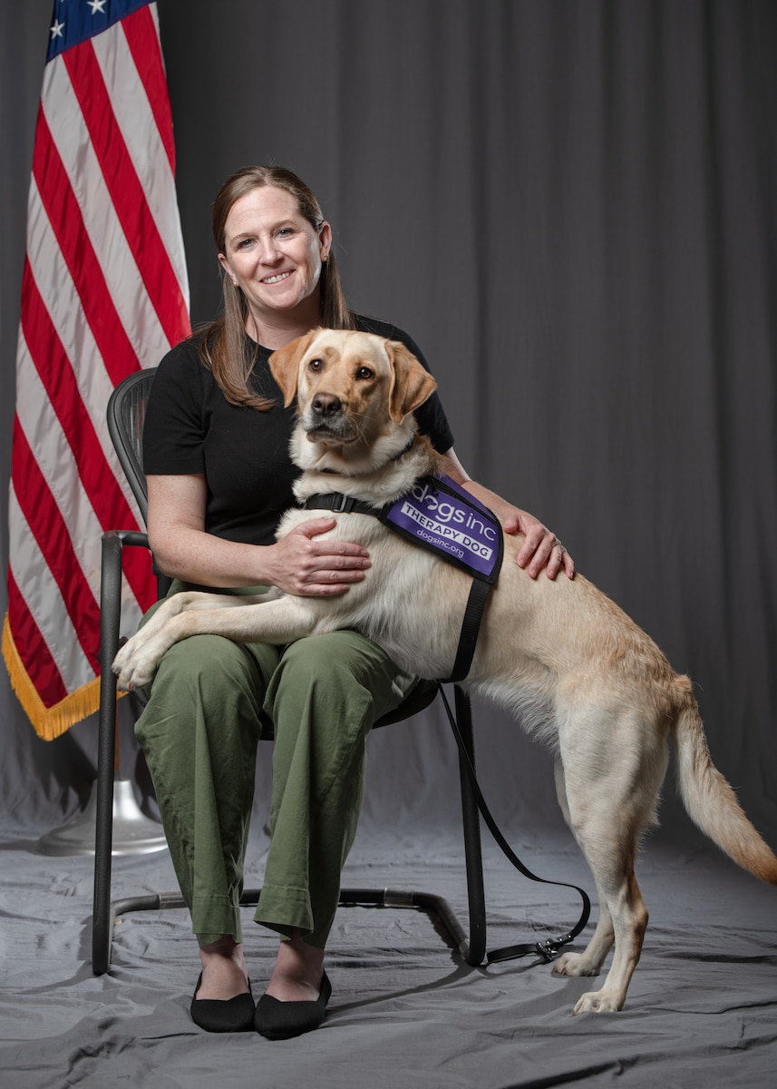 Nichole Gruber, integrated primary prevention workforce integrator, 114th Fighter Wing, leads the Wing’s facility therapy dog initiative to promote mental wellness, support emotional regulation, and strengthen connection among Airmen. (U.S. Air National Guard photo by Staff Sgt. Taylor Solberg)
