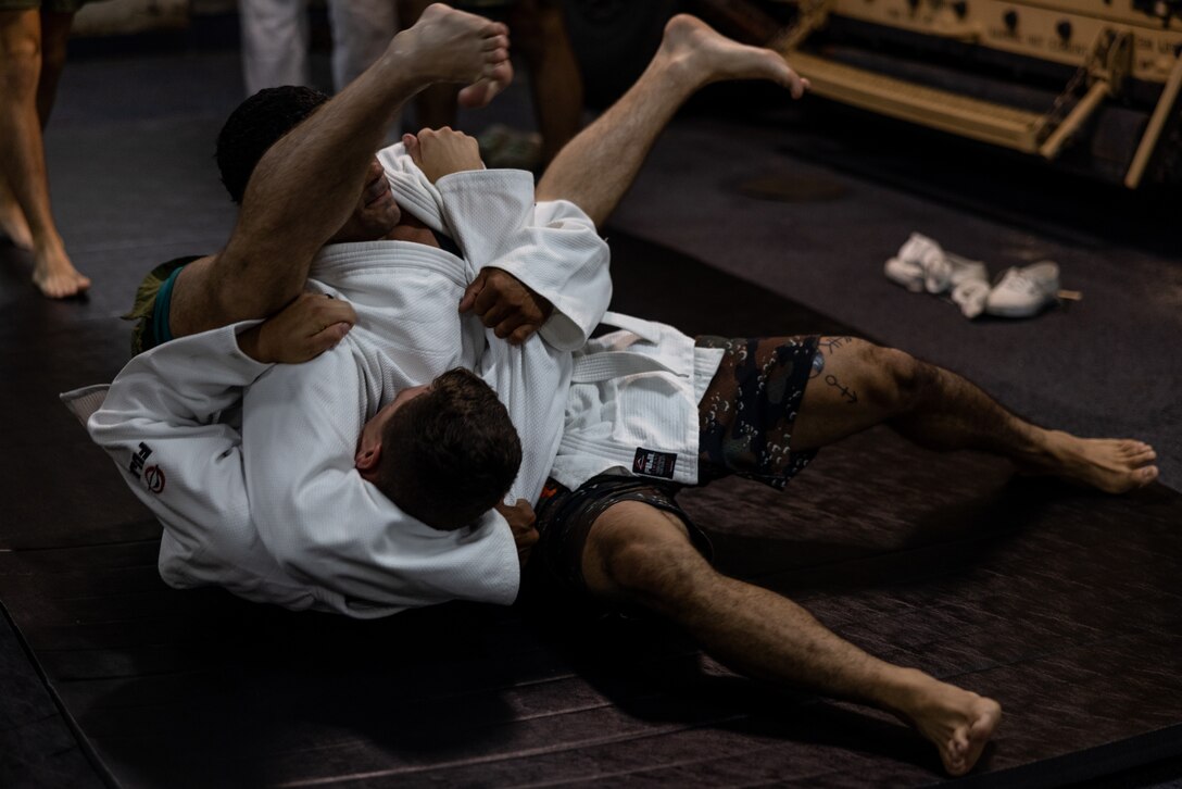 U.S. Marines with 22nd Marine Expeditionary Unit (Special Operations Capable), practice judo techniques during Composite Training Unit Exercise, aboard the San Antonio-class amphibious transport dock ship USS San Antonio (LPD 17), Iwo Jima Amphibious Ready Group, while underway in the Atlantic Ocean, June 28, 2025. During COMPTUEX, the IWOARG and 22nd MEU(SOC) refine tactics, techniques, and procedures to execute warfighting functions that enhance operational readiness and lethality as a unified IWOARG/22 MEU(SOC) team. (U.S. Marine Corps photo by Lance Cpl. Kyle Baskin)