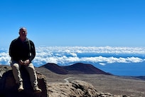 yatt J. Nash, Underwater Electromagnetics Stealth Advisor at Naval Surface Warfare Center Carderock Division, poses for a photo on top of Mauna Kea, Big Island, HI. Nash is one of 10 recipients of the 2025 Assistant Secretary of the Navy (Research, Development and Acquisition) Dr. Delores M. Etter Top Scientists and Engineers of the Year Award. Carderock, the Navy's ship design and innovation powerhouse, provides the technical foundation for the future fleet through world-class research, development, and testing. (Photo courtesy of Wyatt J. Nash)