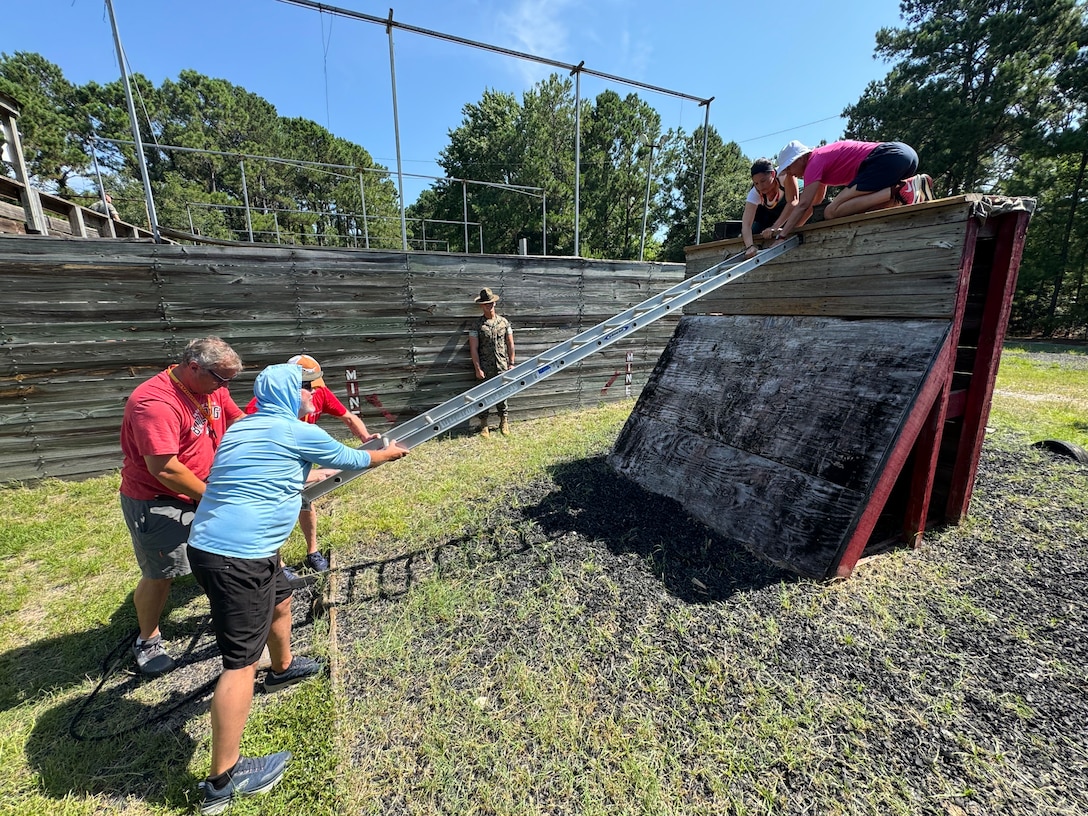Educators with Recruiting Station Columbia conduct group obstacle courses during Educators Workshop at Marine Corps Recruit Depot Parris Island, South Carolina, June 24-27, 2025. Educators Workshop provides an opportunity to high school teachers and school administrators to experience and gain insight on some of the challenges recruits face during Marine Corps recruit training. Attendants of the workshop are informed of the benefits and opportunities the Marine Corps can provide to their students. (U.S. Marine Corps photo by Cpl. Clayton Baker)