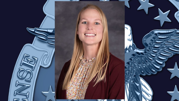headshot of blonde woman with burgundy blazer and multicolored shirt.