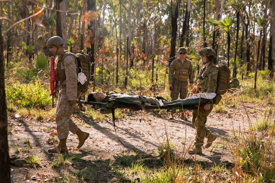 U.S. Navy Petty Officer 2nd Class Eddie VelezSantiago, left, a corpsman with Marine Rotational Force – Darwin 25.3 and an Australian Army medic with 1st Health Battalion, 2nd Health Brigade, evacuate a simulated casualty during a bilateral Tactical Combat Casualty Care, Combat Life Saver course at Robertson Barracks, Darwin, Australia, June 27, 2025.