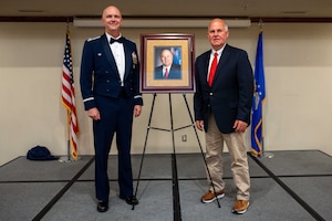 U.S. Air Force Col. Jeff Marshall, 97th Air Mobility Wing (AMW) commander, and Gary Jones, Altus city manager, stand with Jones’s portrait during the Friends of Altus Induction Ceremony, June 26, 2025, at Altus Air Force Base, Oklahoma. To be named a Friend of Altus is the highest honor a local civilian can receive from a 97th AMW Commander. (U.S. Air Force Photo by Airman 1st Class Jonah Bliss)