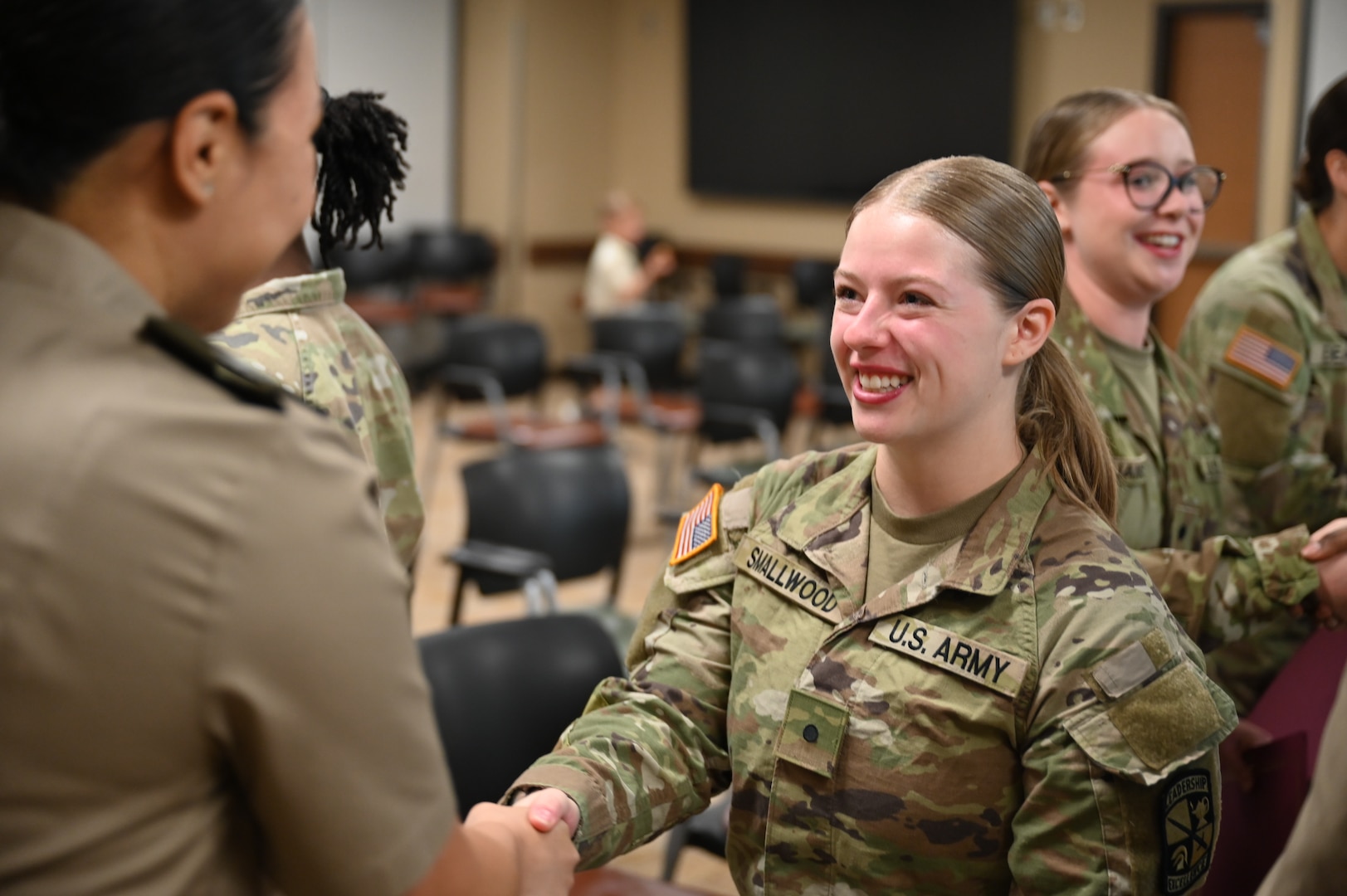 Cadet Reagan Smallwood smiles as she's congratulated after receiving here Nurse Summer Training Program certificate.