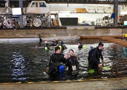 Virginia Tech pilot and hydrodynamics lead Maggie Campbell waves to spectators at the David Taylor Model Basin during the 18th International Submarine Races (ISR18), hosted at Naval Surface Warfare Center, Carderock Division from June 23-27. Campbell is a SMART scholar slated to join Carderock’s Combatant Craft Division after graduation. Carderock, the Navy's ship design and innovation powerhouse, provides the technical foundation for the future fleet through world-class research, development, and testing. (U.S. Navy photo by Alisha Tyer)