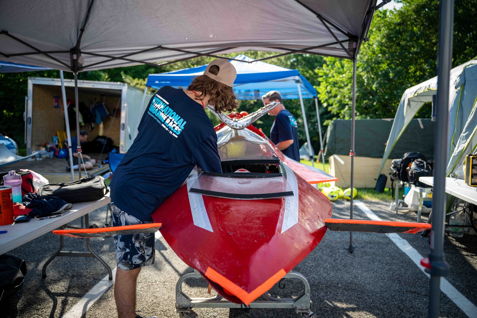 Quinn Barone, 16, completes final checks on Javelin 2.0 before a race run at the 2025 International Submarine Races. He and his father designed and built the sub at home in Annapolis, Maryland. Carderock, the Navy's ship design and innovation powerhouse, provides the technical foundation for the future fleet through world-class research, development, and testing. (U.S. Navy photo by Travis Troller)