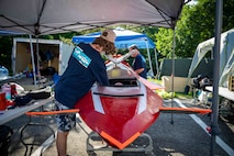 Quinn Barone, 16, completes final checks on Javelin 2.0 before a race run at the 2025 International Submarine Races. He and his father designed and built the sub at home in Annapolis, Maryland. Carderock, the Navy's ship design and innovation powerhouse, provides the technical foundation for the future fleet through world-class research, development, and testing. (U.S. Navy photo by Travis Troller)
