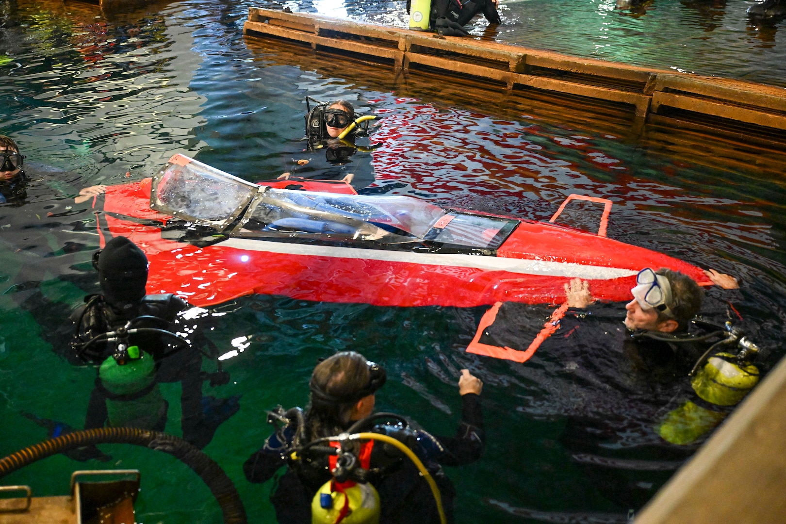 Brian Barone (far right) guides nose stabilization as the family’s custom-built sub, Javelin 2.0, enters the water at Carderock’s David Taylor Model Basin. The team completed multiple successful runs during ISR18. Carderock, the Navy's ship design and innovation powerhouse, provides the technical foundation for the future fleet through world-class research, development, and testing.  (U.S. Navy photo by Devin Pisner)