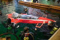 Brian Barone (far right) guides nose stabilization as the family’s custom-built sub, Javelin 2.0, enters the water at Carderock’s David Taylor Model Basin. The team completed multiple successful runs during ISR18. Carderock, the Navy's ship design and innovation powerhouse, provides the technical foundation for the future fleet through world-class research, development, and testing.  (U.S. Navy photo by Devin Pisner)