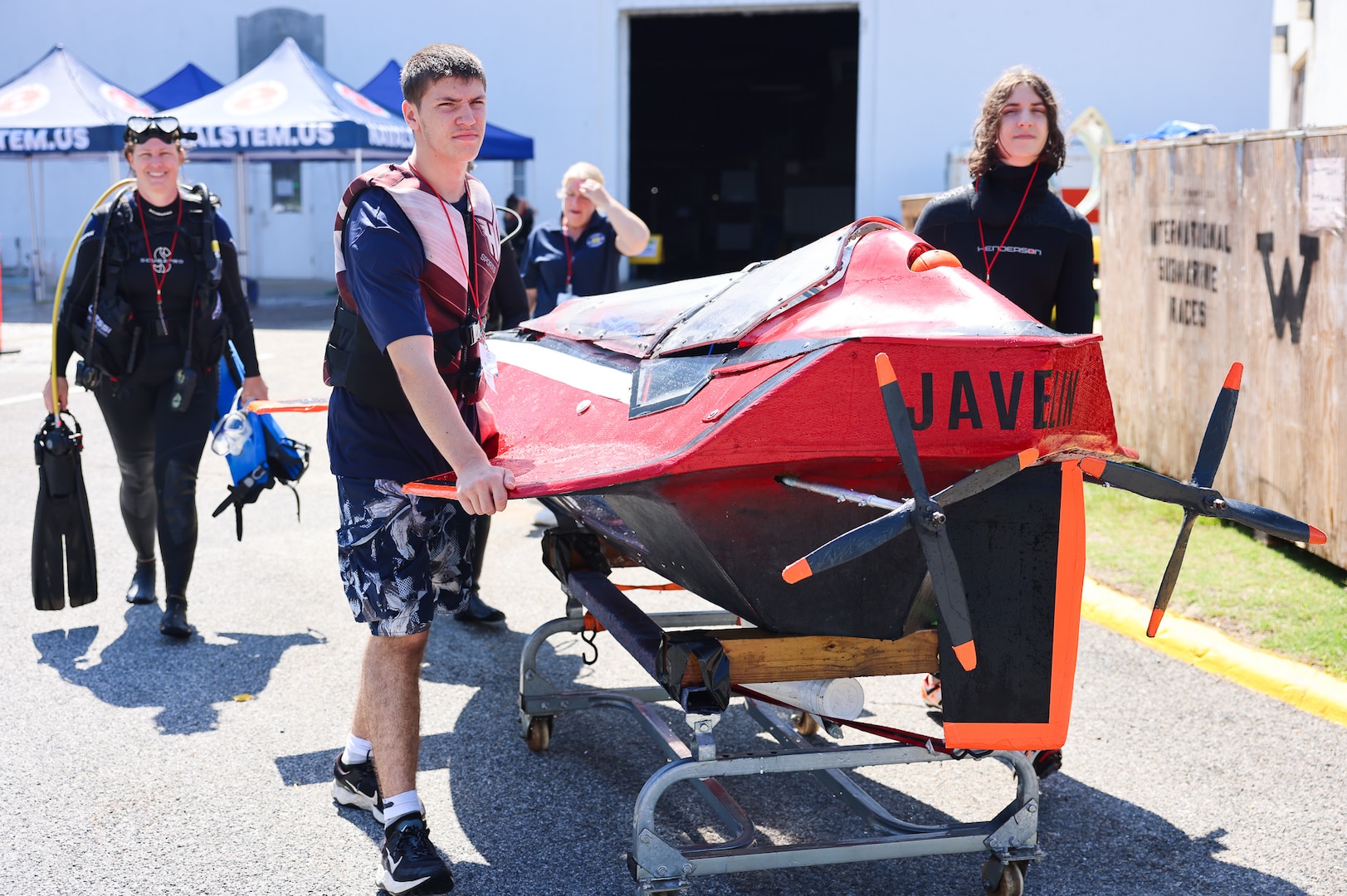 From left: Elizabeth, Zane, and Quinn Barone return Javelin 2.0 to their pit area after a successful run during the 2025 International Submarine Races. The Annapolis-based family competed as the only independent team in this year’s race. Carderock, the Navy's ship design and innovation powerhouse, provides the technical foundation for the future fleet through world-class research, development, and testing. (U.S. Navy photo by Kristin Behrle)