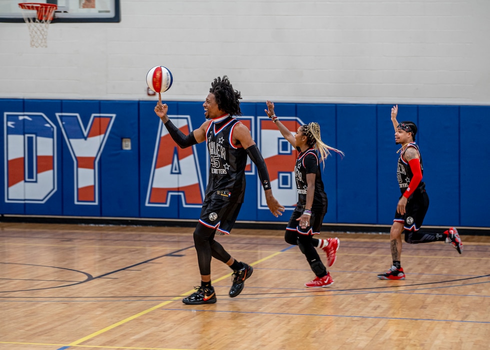 Harlem Globetrotters run and wave at the crowd at Moody Air Force Base, Georgia, June 26, 2025. The legendary team is known for combining athleticism and      comedy and showmanship into a one-of-a-kind basketball experience. (U.S. Air Force photo by Senior Airman Leonid Soubbotine)