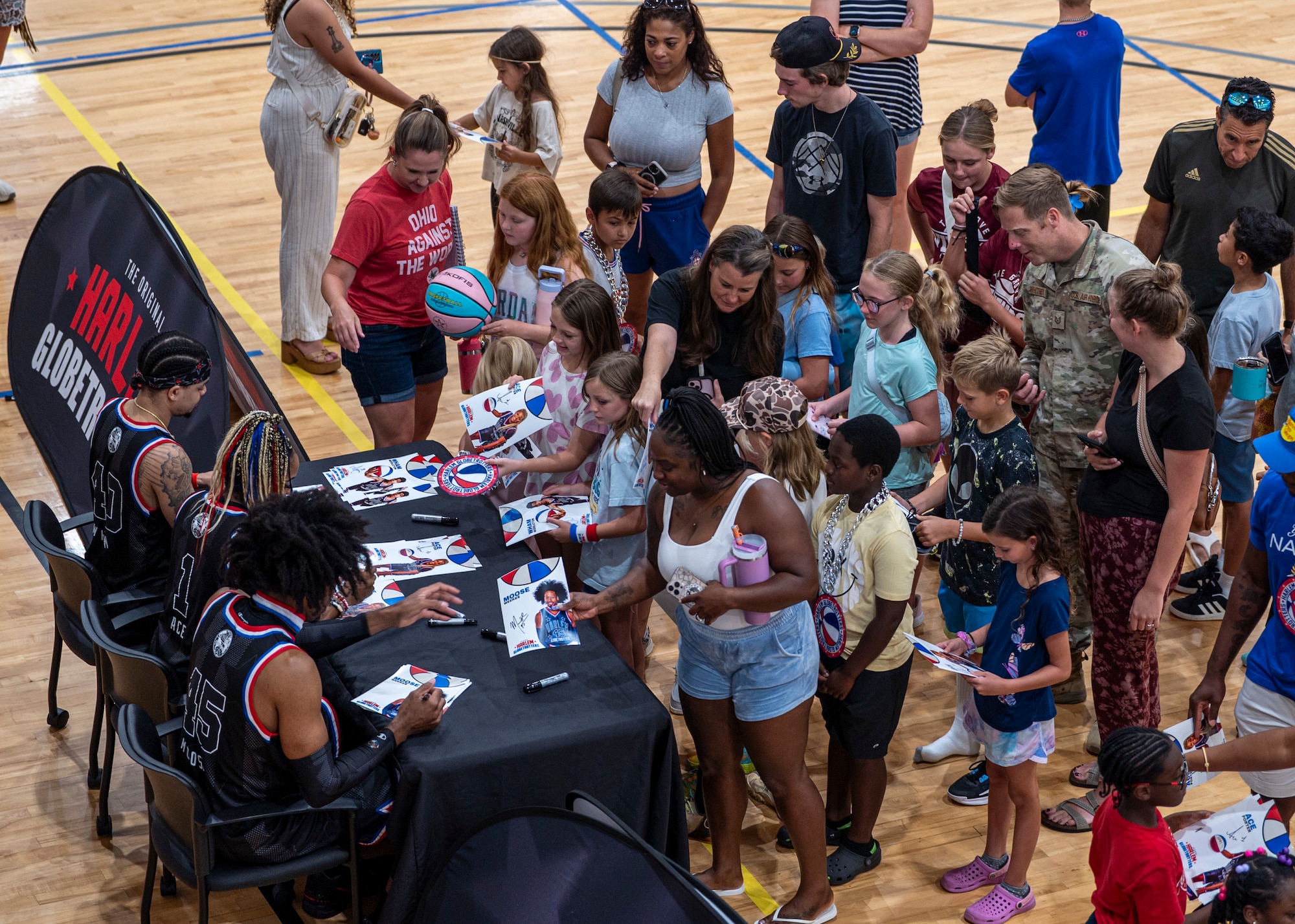 Harlem Globetrotters sign autographs at Moody Air Force Base, Georgia, June 26, 2025. The Globetrotters use basketball as a way to connect with communities and spread positivity around the world. (U.S. Air Force photo by Senior Airman Leonid Soubbotine)
