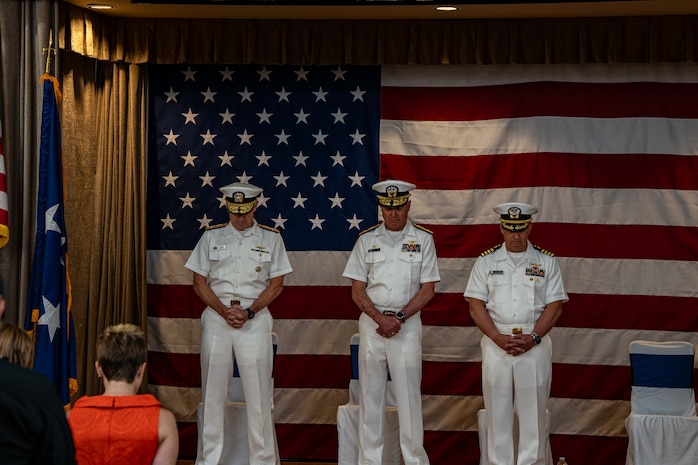 250630-N-EN156-1057 SILVERDALE, Wash. (June 30, 2025) — Members of the official party bow their heads during the benediction at a change of command ceremony held in Bangor Plaza at Naval Base Kitsap-Bangor, June 30, 2025. During the ceremony Capt. Jason Sherman relieved Rear Adm. Mark Sucato as commander, Navy Region Northwest. Commander, Navy Region Northwest provides consolidated base operations support for Navy activities in Washington, Oregon, Alaska, Idaho, Montana, Wyoming, North Dakota, South Dakota, Nebraska, Minnesota and Iowa. The commander oversees the assigned shore organization and provides facilities and space management, exercise coordination, and support to homeported and transient ships, submarines and aircraft as well as afloat and ashore tenants, military and family members. (U.S. Navy photo by Lt. Zachary Anderson)