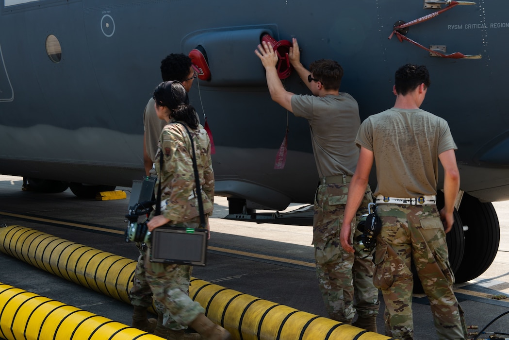 Group of airmen outside working on a plane.