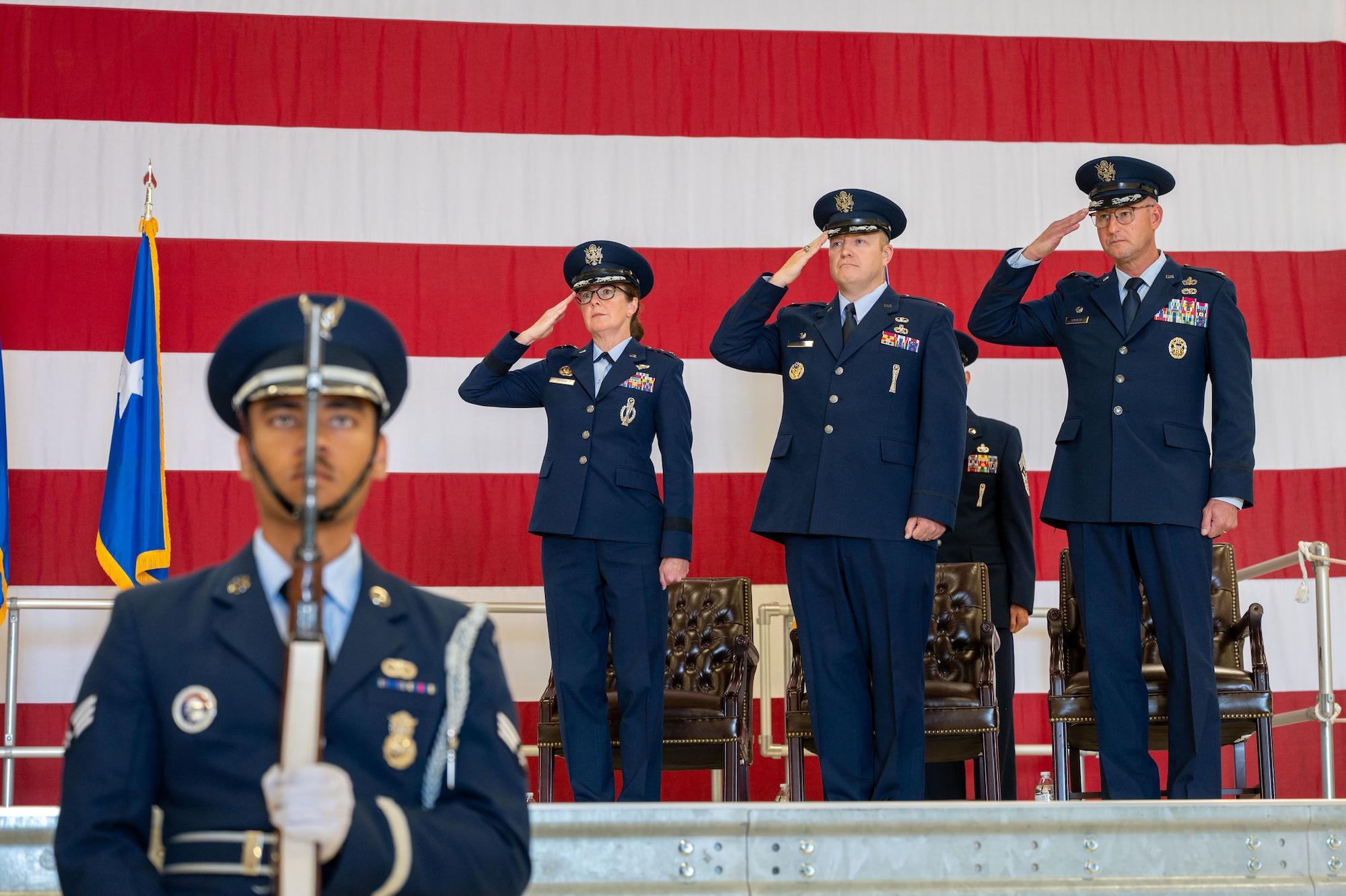 People salute the flag during a ceremony