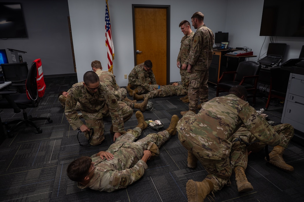 A group of people some laying down and others standing.