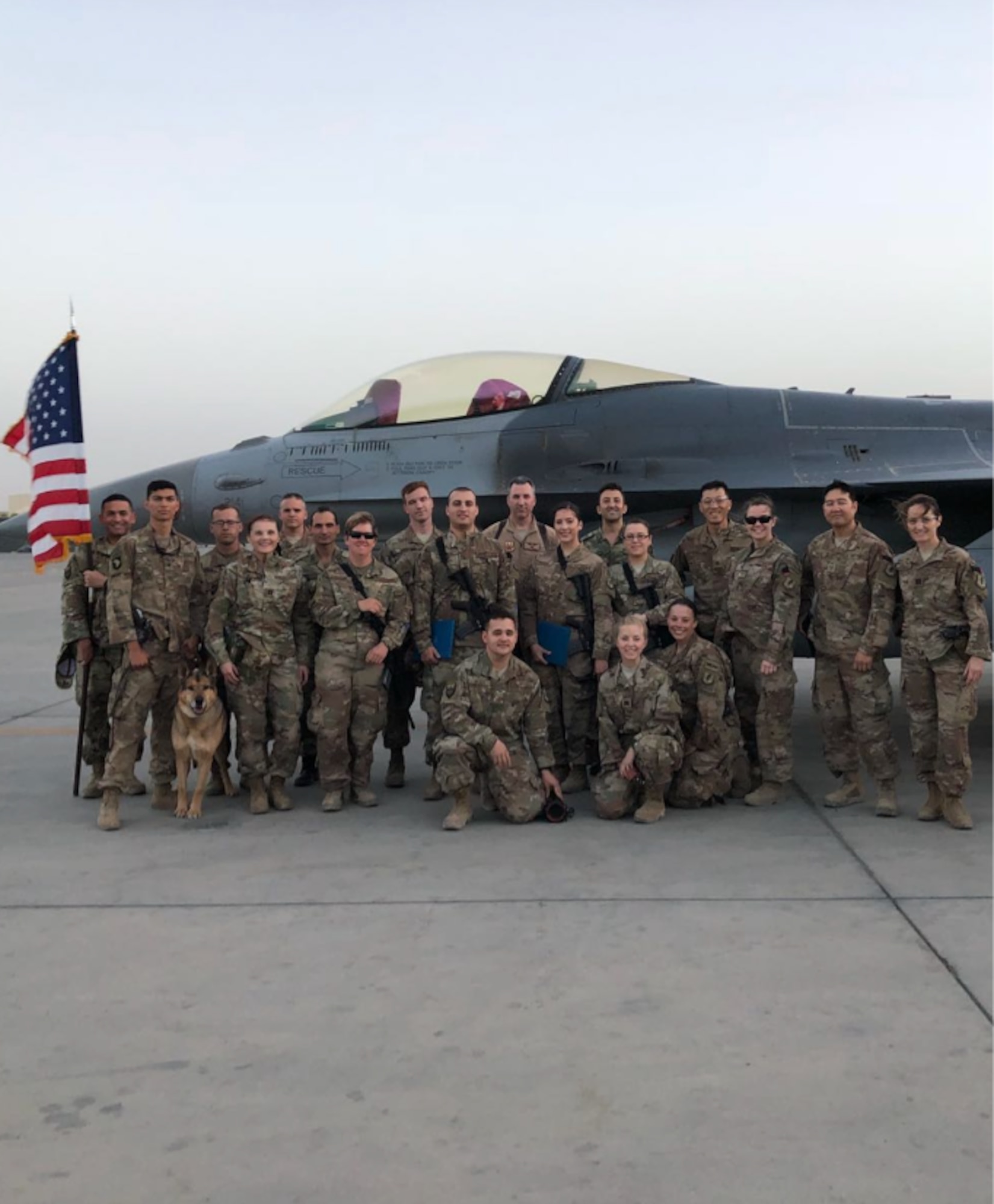 Group photo of military members in front of airplane