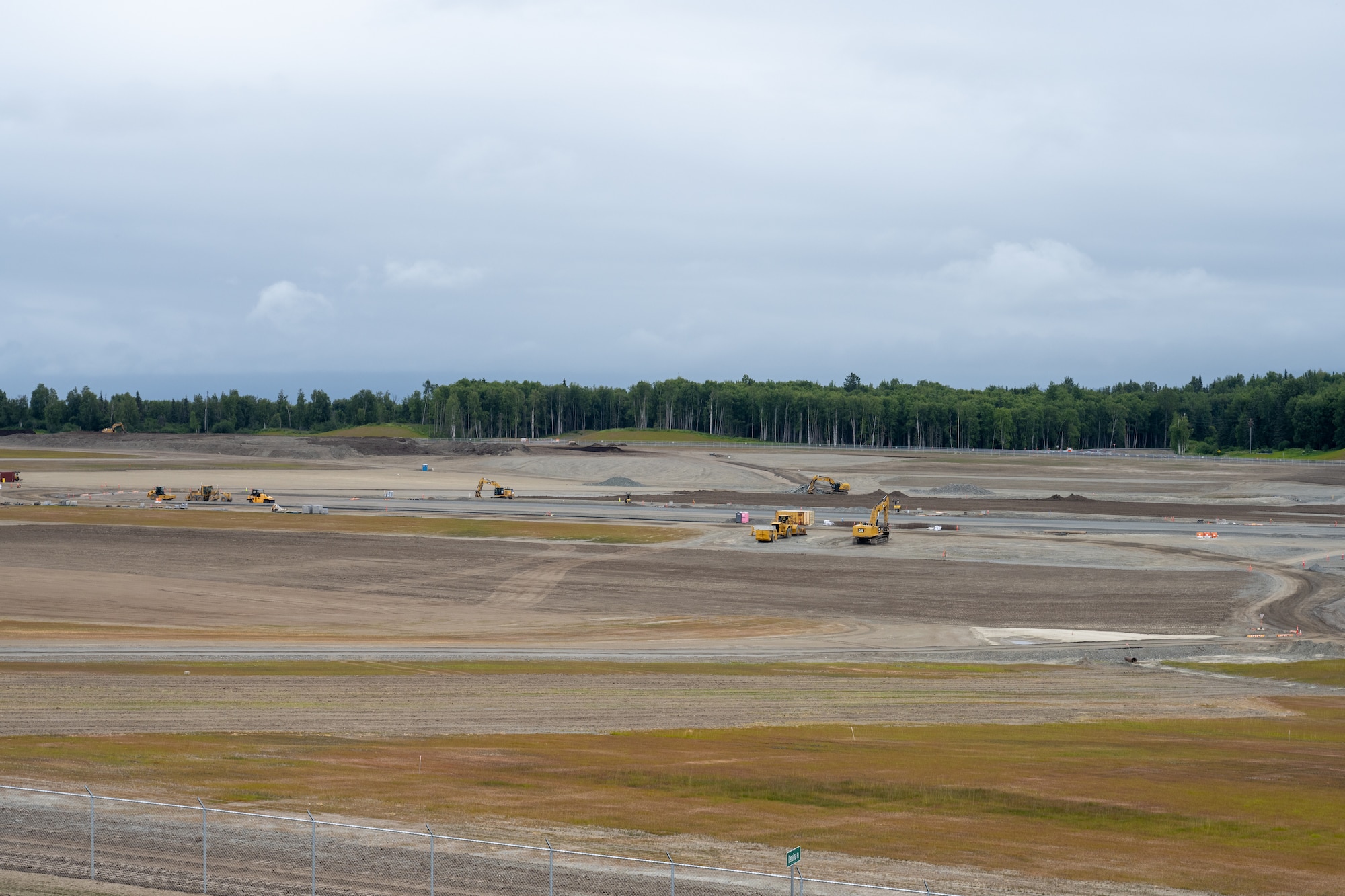 The Kiewit Construction Team continues to work on the expansion of the flight-line on Joint Base Elmendorf-Richardson, Alaska, June 30. This project began in the fall of 2022 and the team continues to make great efforts to complete it. One of two on Elmendorf Field, Runway 16/34 will be extended 2,900 feet to make the length of the runway 10,000 feet and the southern threshold of the runway will shift 400 feet to the north to meet airfield design requirements. The project will also extend the two parallel taxiways; add an arm-disarm pad; upgrade the airfield lighting and the instrument landing system; re-route Airlifter Drive around the north end of the extension; relocate airfield perimeter fencing and reconfigure utility services in the area. Upon completion of the runway extension, JBER will be capable of accommodating any airframe in the Department of Defense, regardless of the weather.