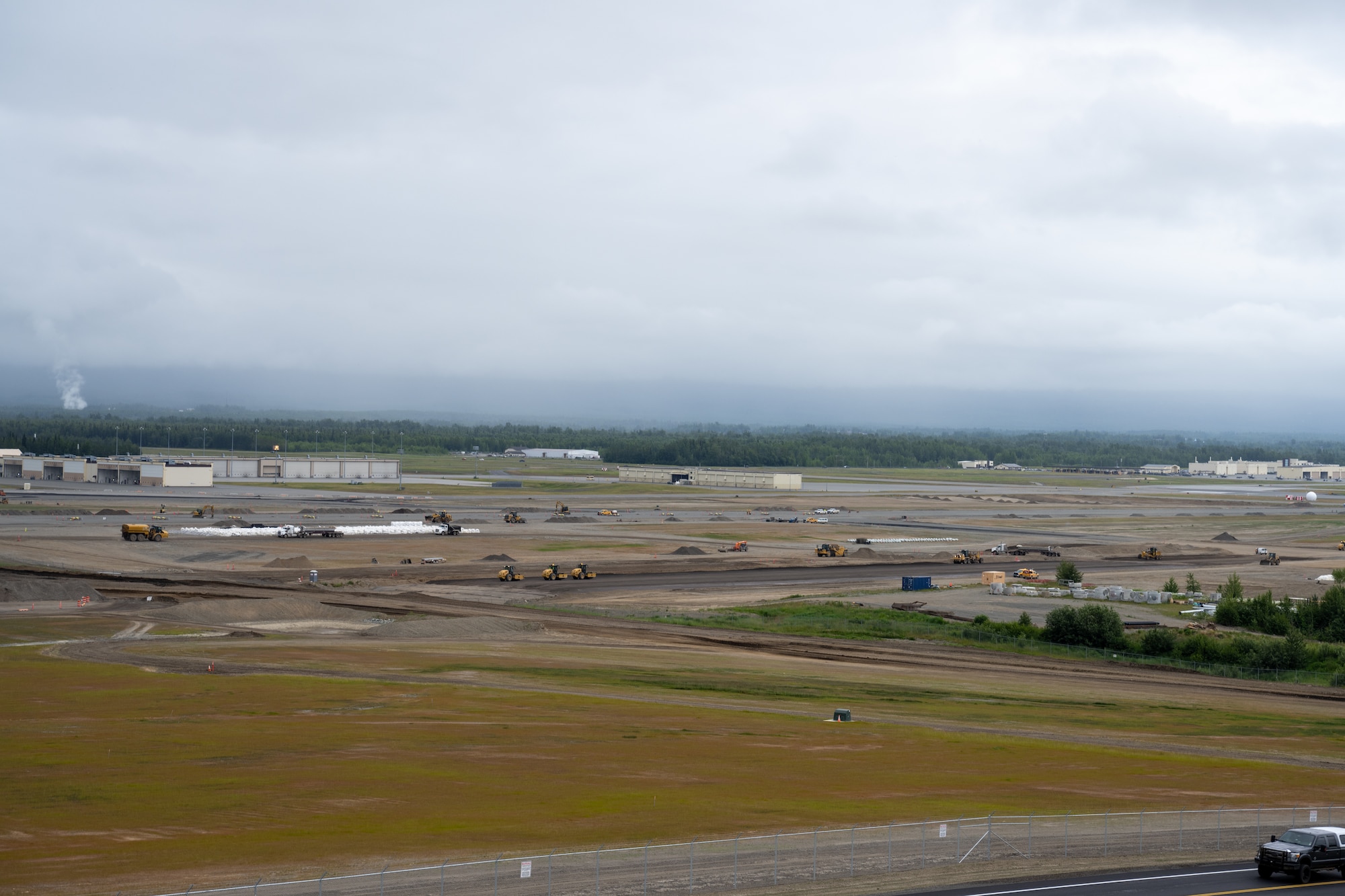 The Kiewit Construction Team continues to work on the expansion of the flight-line on Joint Base Elmendorf-Richardson, Alaska, June 30. This project began in the fall of 2022 and the team continues to make great efforts to complete it. One of two on Elmendorf Field, Runway 16/34 will be extended 2,900 feet to make the length of the runway 10,000 feet and the southern threshold of the runway will shift 400 feet to the north to meet airfield design requirements. The project will also extend the two parallel taxiways; add an arm-disarm pad; upgrade the airfield lighting and the instrument landing system; re-route Airlifter Drive around the north end of the extension; relocate airfield perimeter fencing and reconfigure utility services in the area. Upon completion of the runway extension, JBER will be capable of accommodating any airframe in the Department of Defense, regardless of the weather.