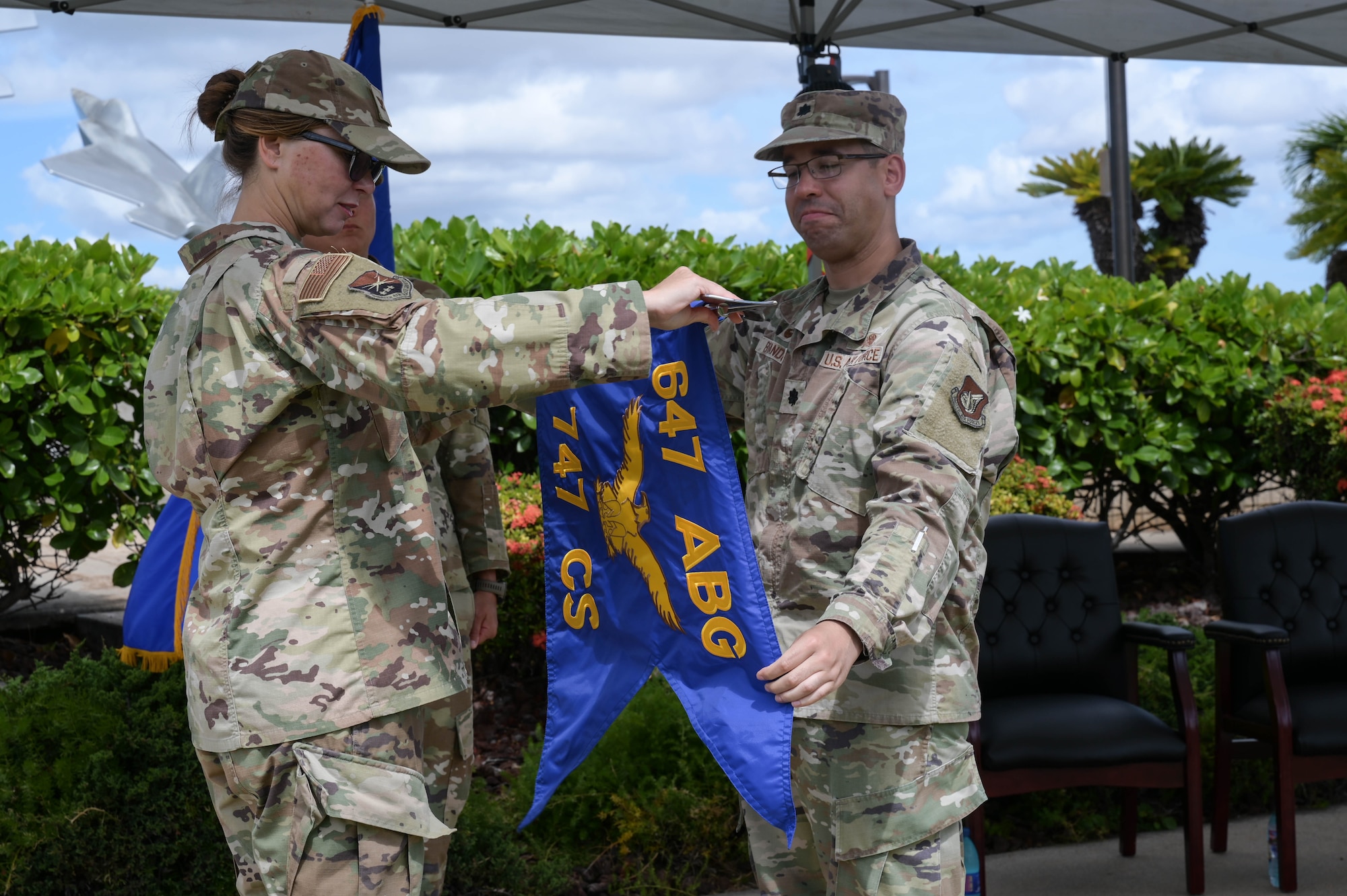 Air Force commanders unfurling a guidon.
