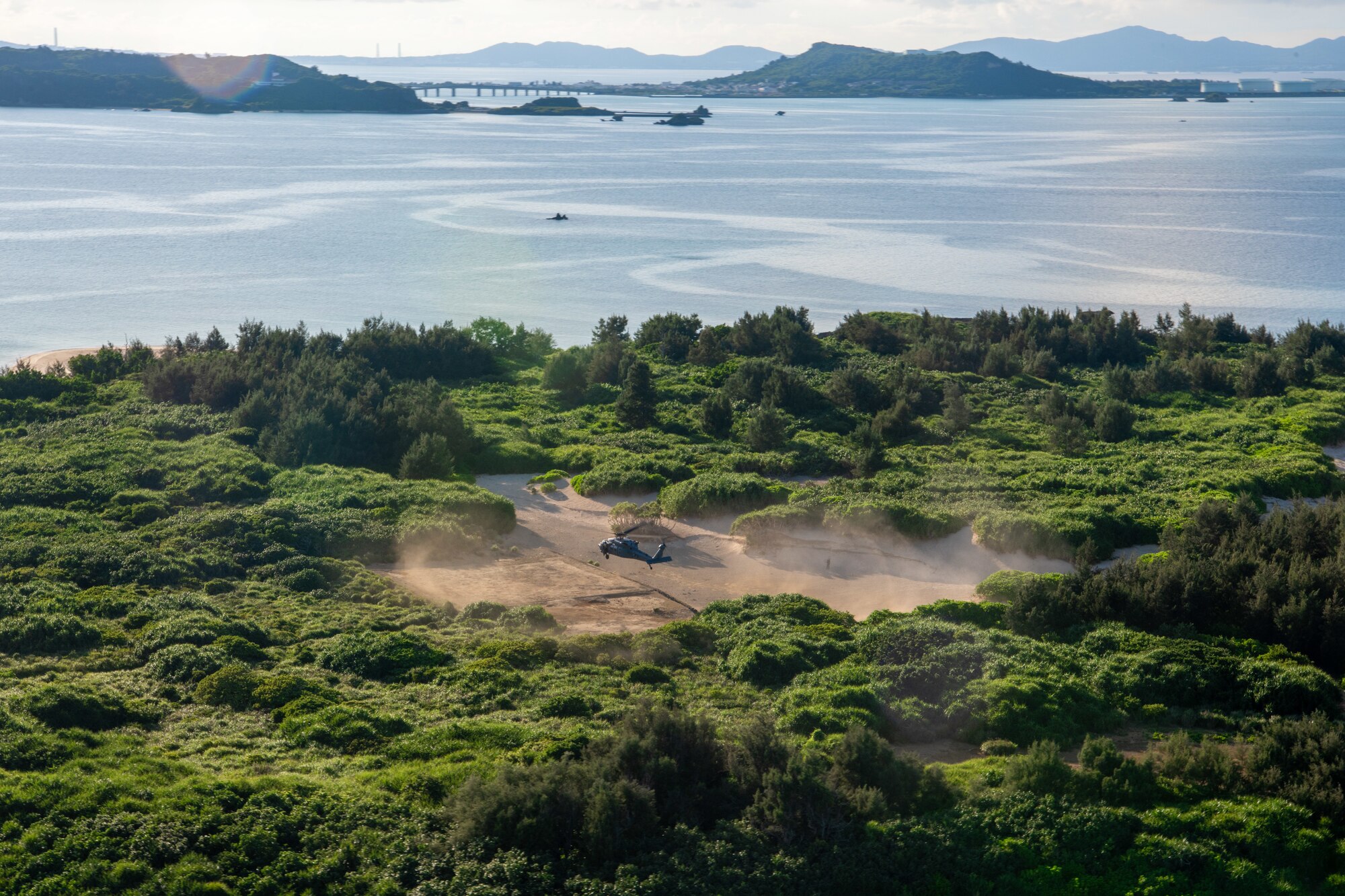 birds eye view of a helicopter landing on an island