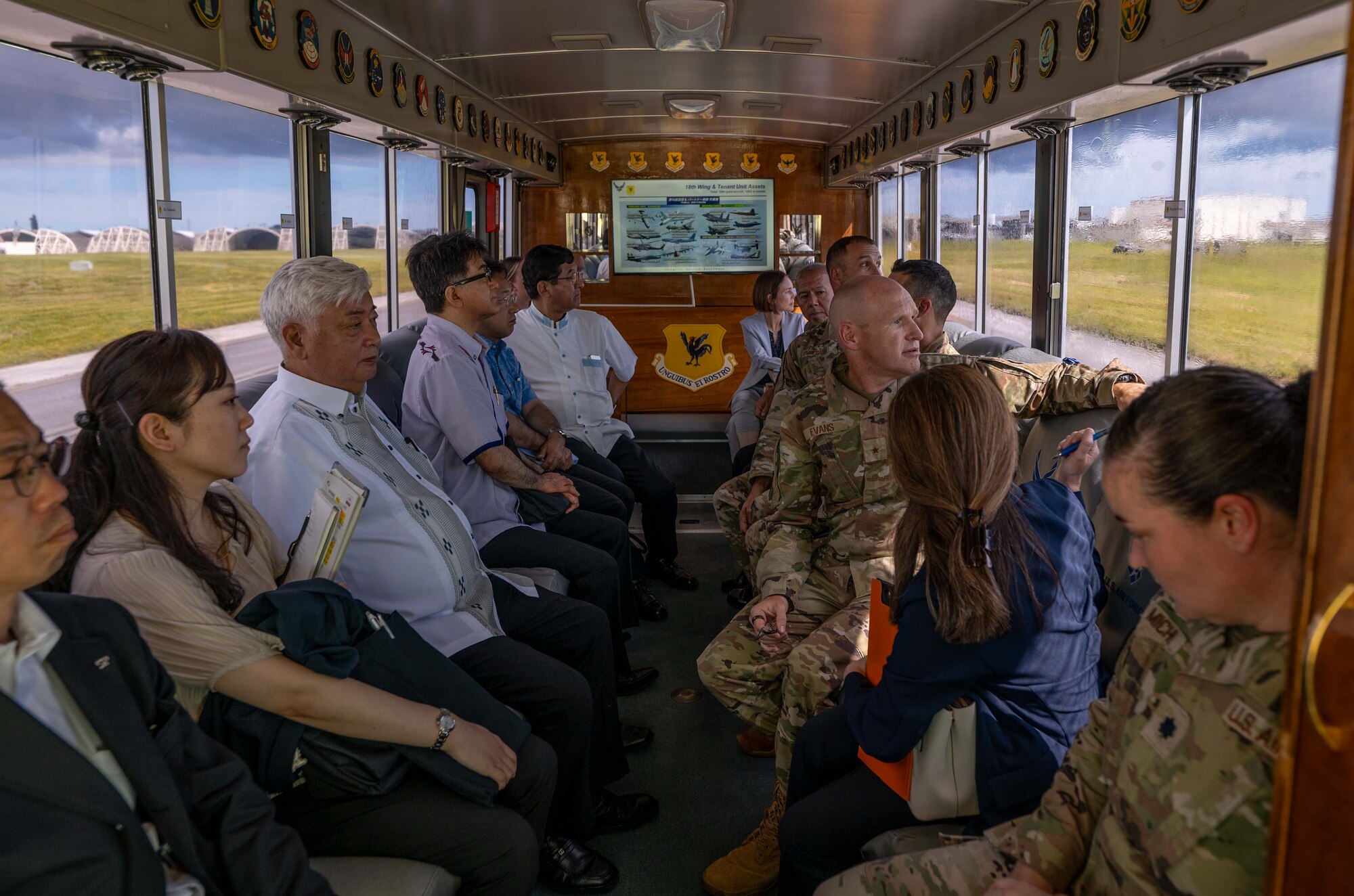 U.S. Air Force Brig. Gen. Nicholas Evans, center right, 18th Wing commander, and Honorable Gen Nakatani, center left, Japan's Minister of Defense, tour the flightline at Kadena Air Base, Japan, June 23, 2025.