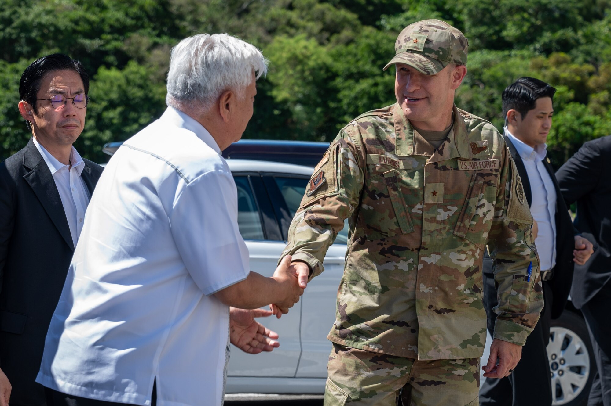 U.S. Air Force Brig. Gen. Nicholas Evans, right, 18th Wing commander, shakes hands with Honorable Gen Nakatani, Japan's Minister of Defense, at Kadena Air Base, Japan, June 23, 2025.