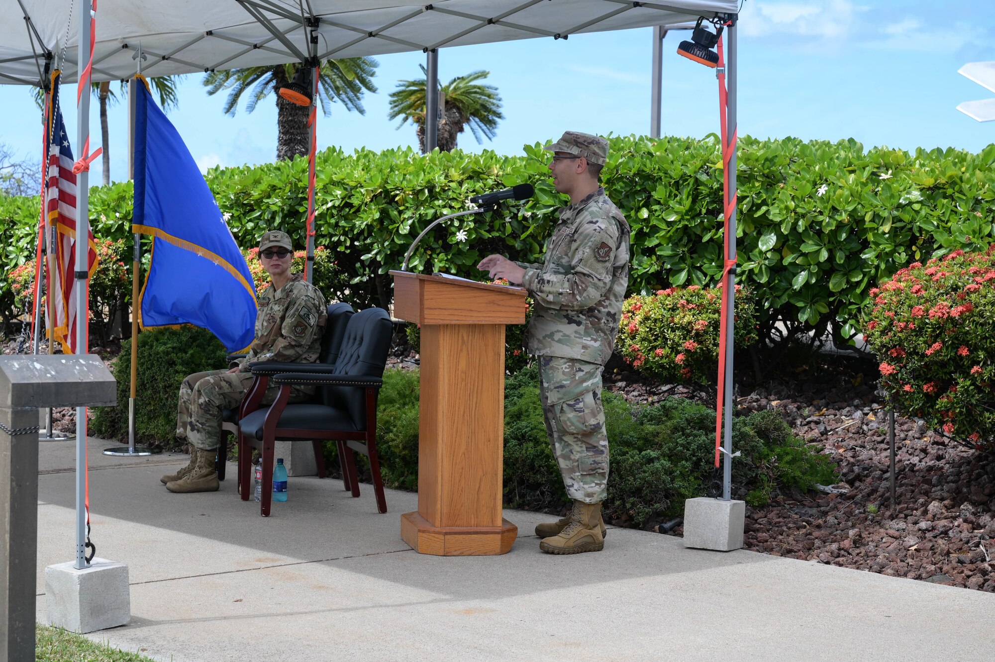 Air Force commander speaking at a podium.