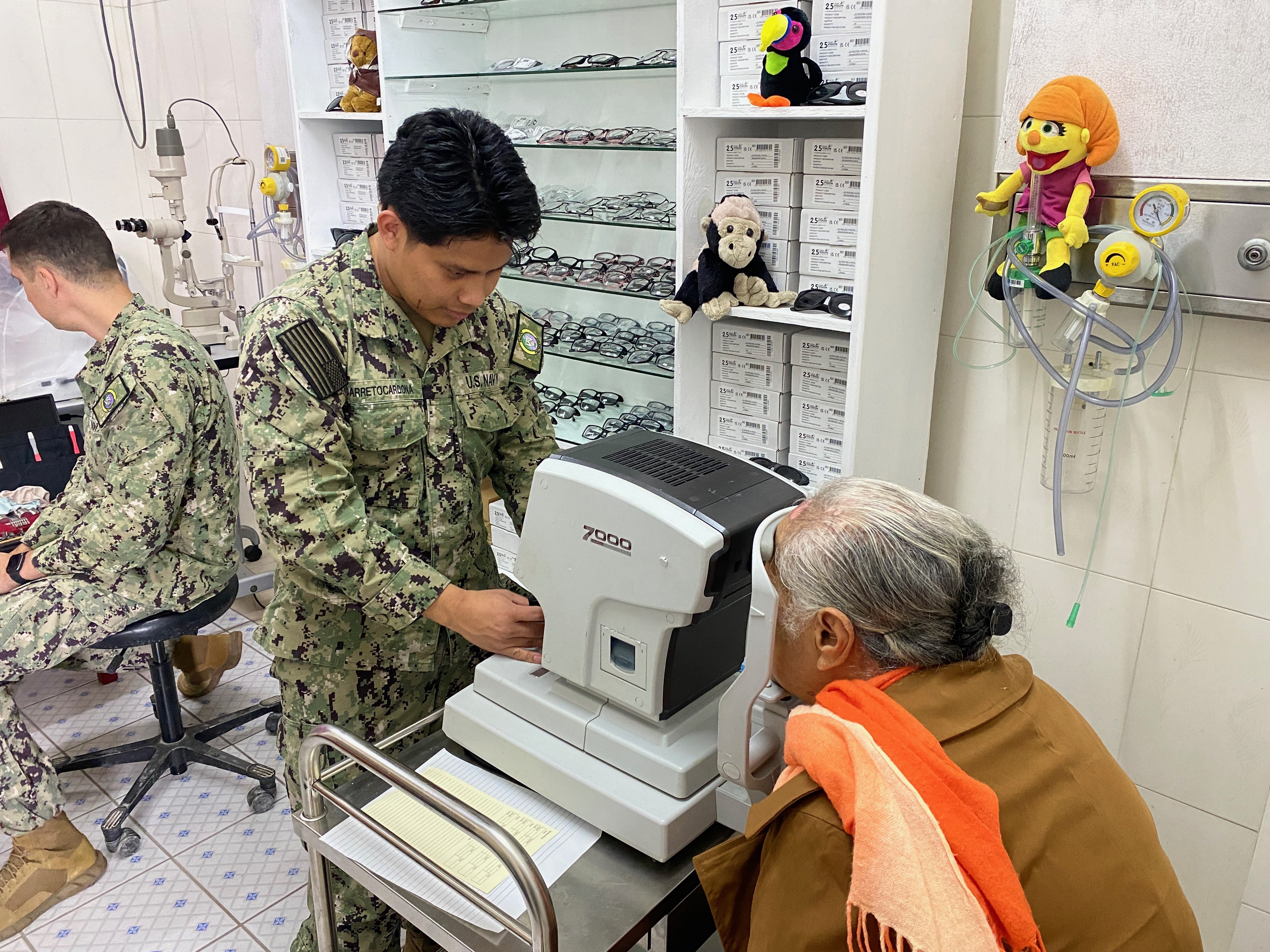 Hospitalman Anthony Carretocardona conducts an eye exam for a local resident at Vaiola Hospital as part of Pacific Partnership 2025 (PP-25) in Nuku’alofa, Tonga, June 23, 2025.