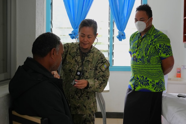U.S. Navy Cmdr. Shirleen Sulatan, center, Nurse Practitioner deployed in support of Pacific Partnership 2025 (PP-25), assists a local patient during a health consultation at Mu’a Health Centre as part of PP-25 in Nuku’Alofa, Tonga, June 24, 2025.