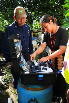 U.S. Public Health Service Lt. Sung Jik Park, left, Environmental Health Officer with Pacific Partnership 2025 (PP-25), trains a local public health official in the quality testing of public water sources with a Palintest kit during PP-25 in Nuku’Alofa, Tonga, June 26, 2025.