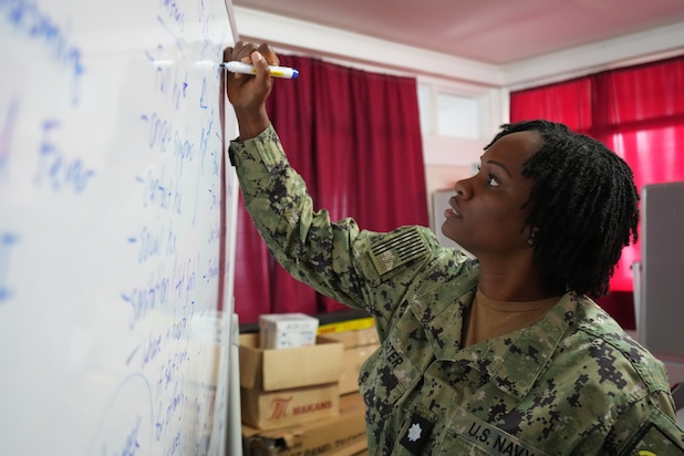 U.S. Navy Cmdr. Christina Carter, public health nurse deployed in support of Pacific Partnership 2025 (PP-25), writes on a whiteboard during a tabletop training exercise with local nurses of Vaiola Hospital as part of PP-25 in Nuku’Alofa, Tonga, June 26, 2025.