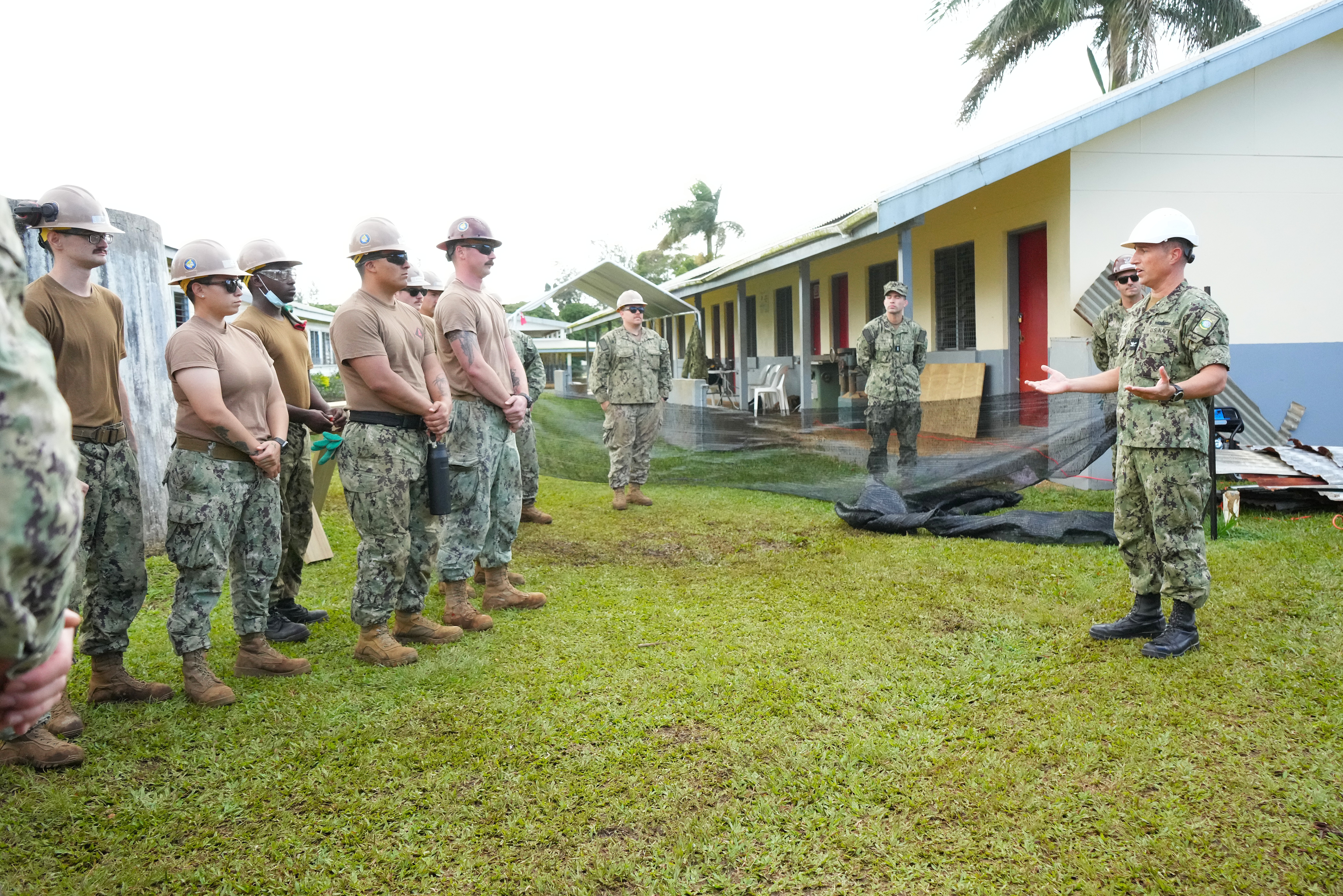 U.S. Navy Capt. Mark B. Stefanik, right, mission commander of Pacific Partnership 2025 (PP-25), speaks to Sailors assigned to Naval Mobile Construction Battalion 4 during engineering repairs at Tonga College ‘Atele campus as part of PP-25 in Nuku’Alofa, Tonga, June 26, 2025.