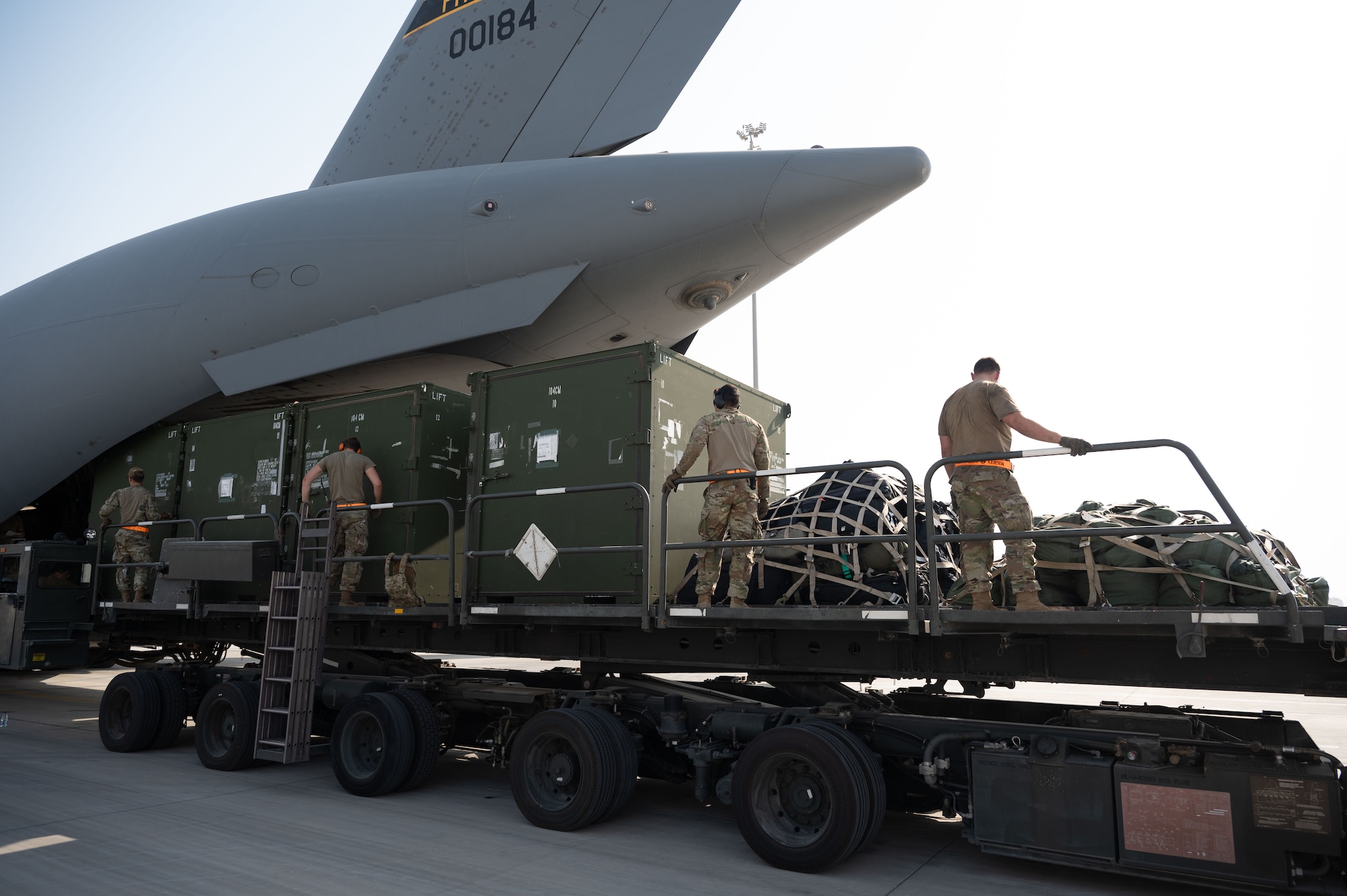 U.S. Air Force Airmen assigned to the 379th Expeditionary Air Base Group use a K-loader to load equipment during a rapid aircraft departure within the U.S. Central Command area of responsibility June 15, 2025. Rapid aircraft departures are used to increase the survivability of personnel and airframes. (U.S. Air Force photo by Senior Airman Dieondiere Jefferies)