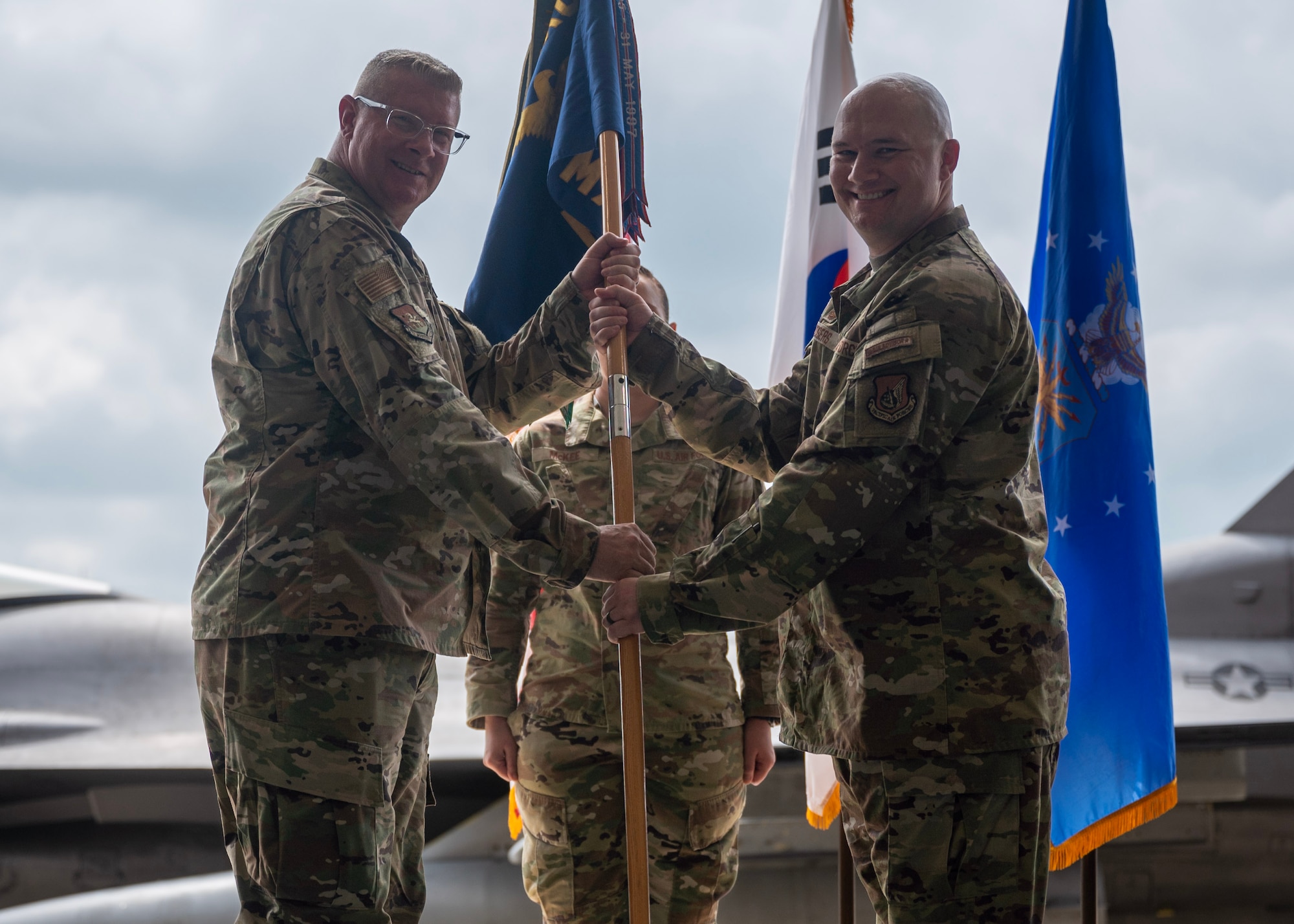 U.S. Air Force Maj. Jedidiah Rodgers, right, incoming 51st Maintenance Squadron commander, assumes command from Col. Kenneth Beebe, left, 51st Maintenance Group commander, during a Change of Command ceremony at Osan Air Base, Republic of Korea, July 2, 2025. Prior to assuming command, Rodgers commanded the 35th Maintenance Group Staff, 35th Fighter Wing, Misawa Air Base, Japan. (U.S. Air Force photo by Staff Sgt. Sarah Williams)